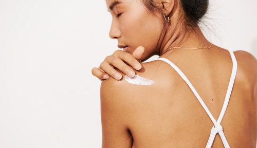 a woman applying one of the best creams for back pain