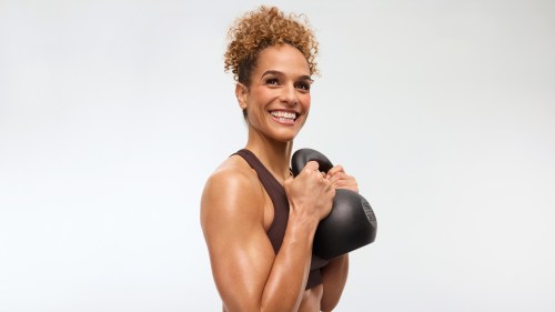 Peloton instructor Jess Sims holds a kettlebell