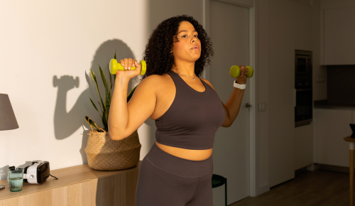 woman exercising at home with strength-training essentials from walmart