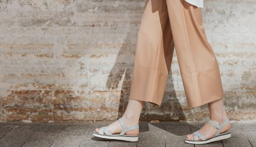 Close up shot of woman walking in comfortable sandals.