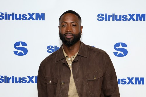 photo of nba player Dwyane Wade in a brown jacket and tan shirt standing in front of a white background with the siriusxm logo