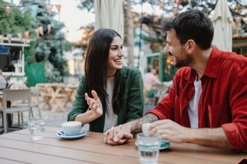 couple sitting and talking on a date and hoping to avoiding floodlighting or oversharing