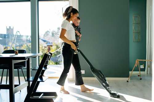 woman vacuuming with baby