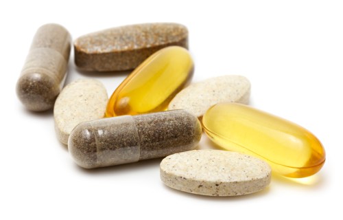 Natural vitamin supplements on white background