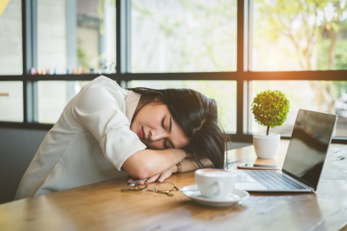 Freelancer businesswoman tired after working in a coffee shop