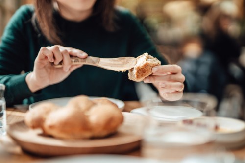 Woman spreading butter on bread