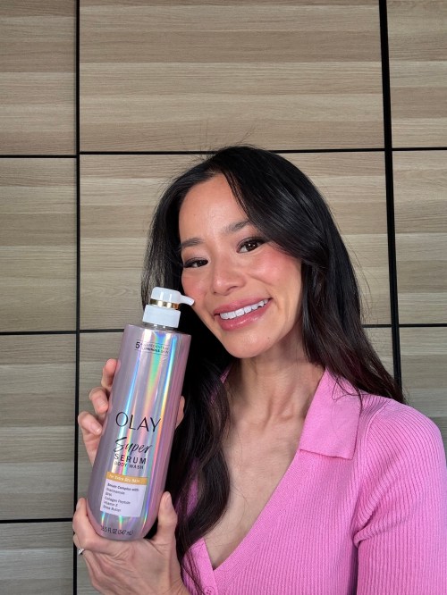 jamie chung holding a bottle of olay body wash