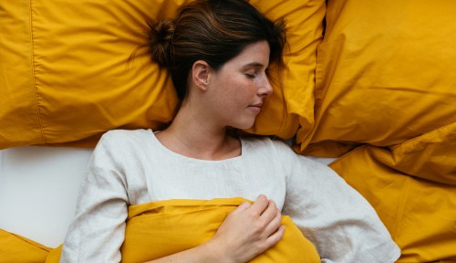 A woman is asleep, in this visual of having a dream of someone dying.