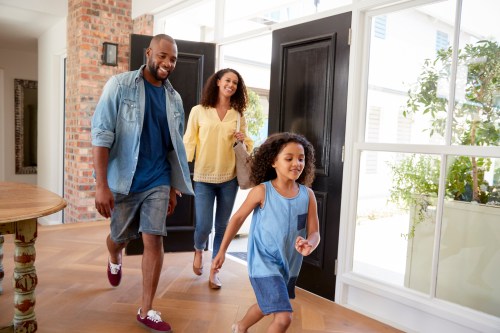 Mom, dad, and daughter coming home from running errands