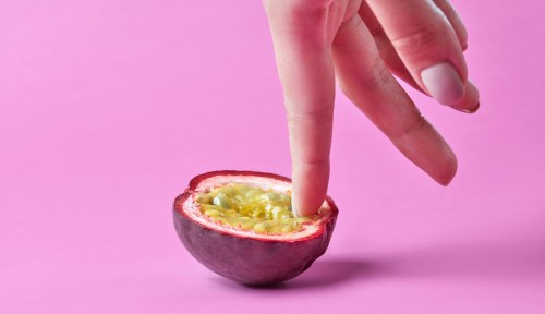 A woman demonstrates how to finger yourself on a fruit.