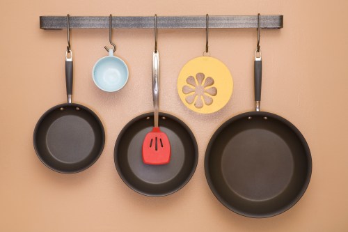 Pans and Utensils Hanging on Kitchen Wall